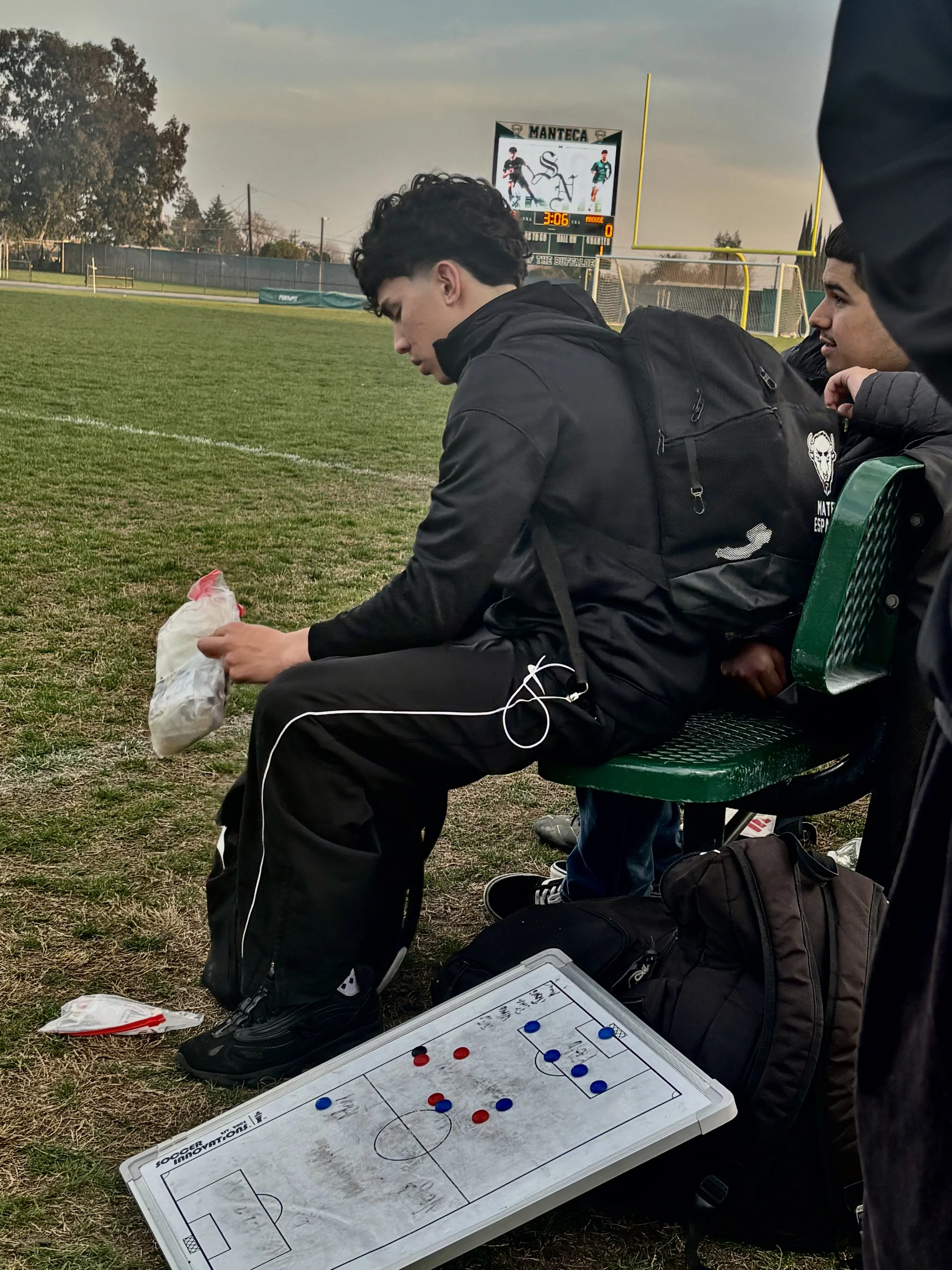  Mateo Esparza grabbing the stuff he needs in from the med bag, in order to be prepared for his senior night against Mountain house, February 5, 2026. (Christian Ambriz/The Tower) 