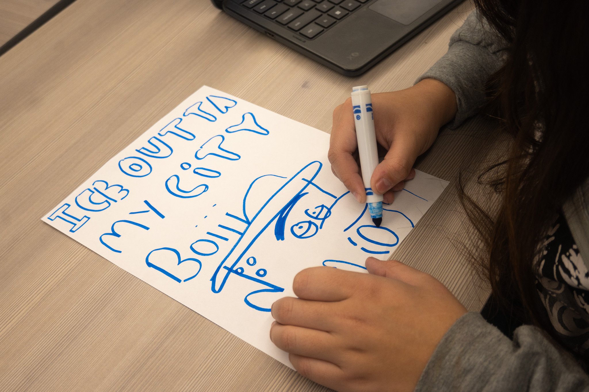 A tennis athlete works on her English honors assignment during class time. 