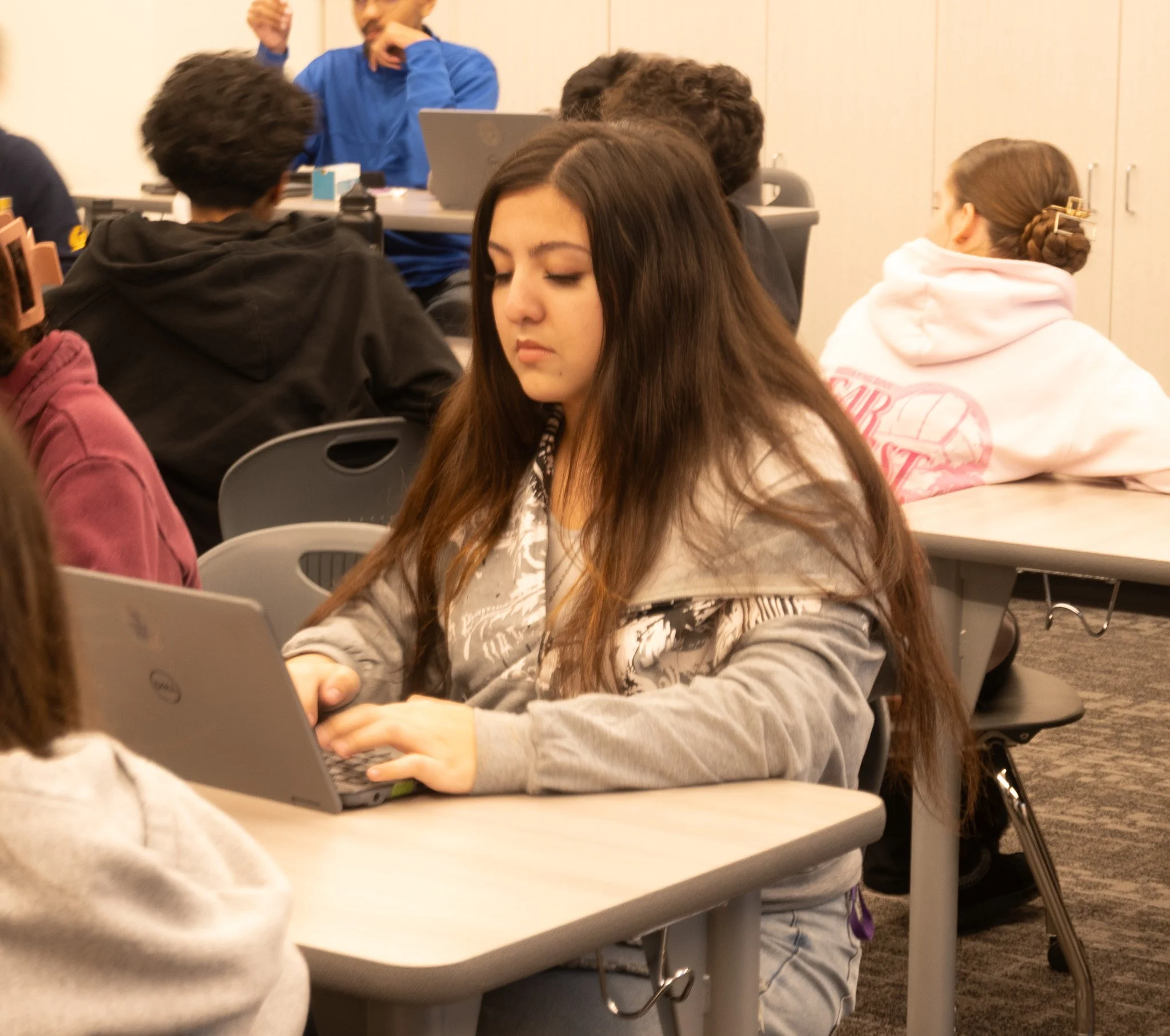 A tennis athlete works on her English honors assignment during class time. 