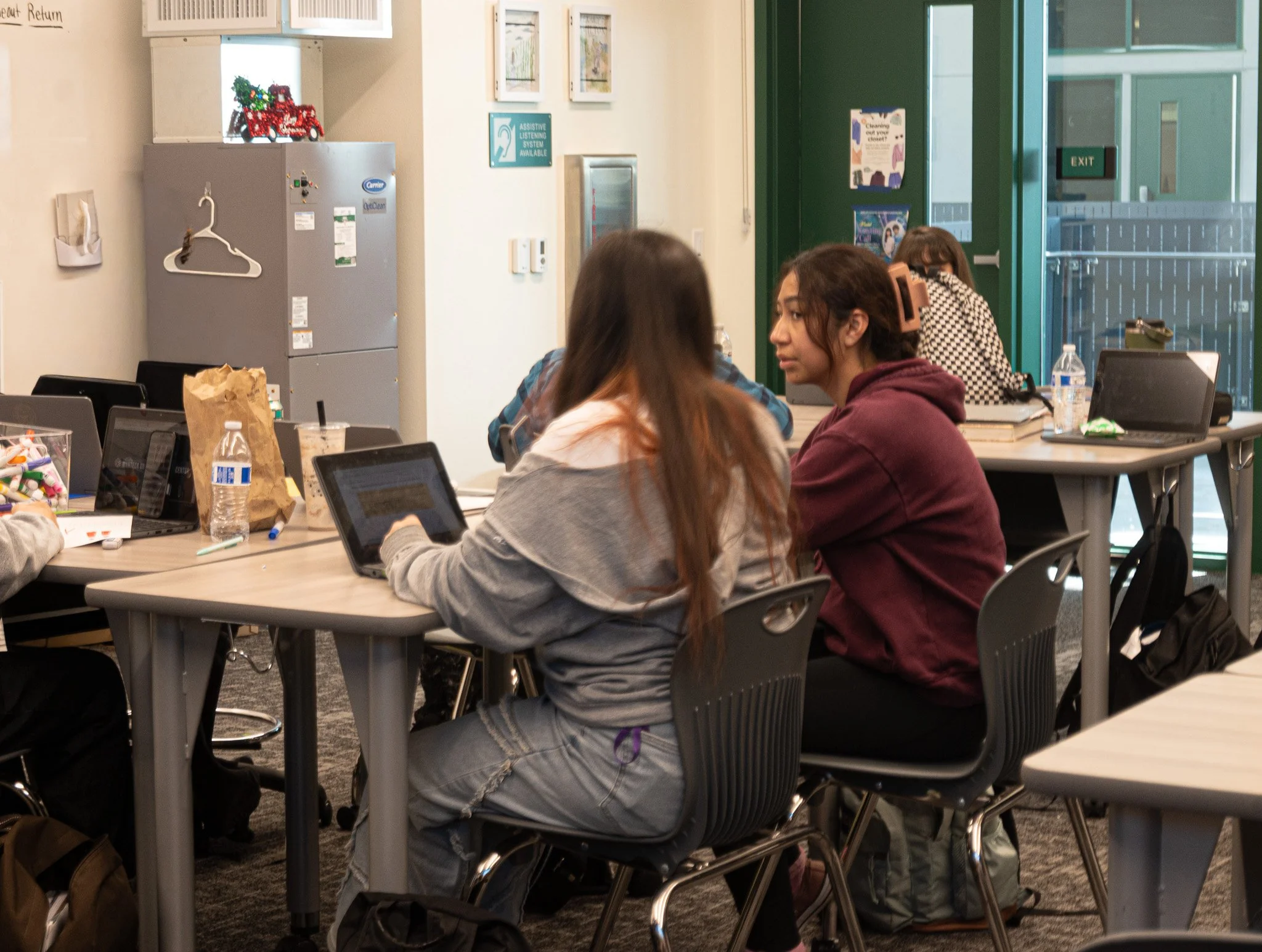 A tennis athlete works on her English honors assignment during class time. 