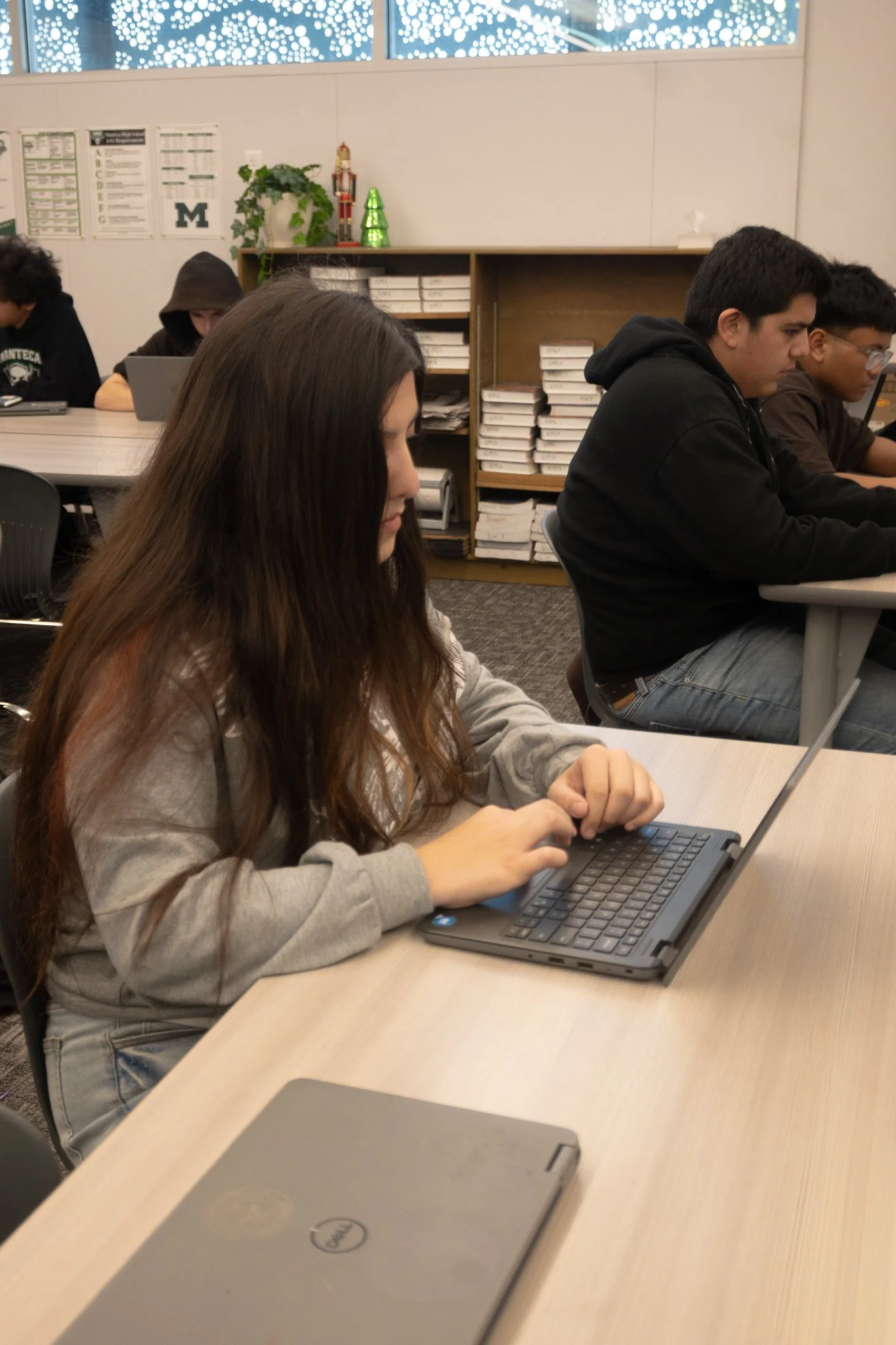 A tennis athlete works on her English honors assignment during class time. 