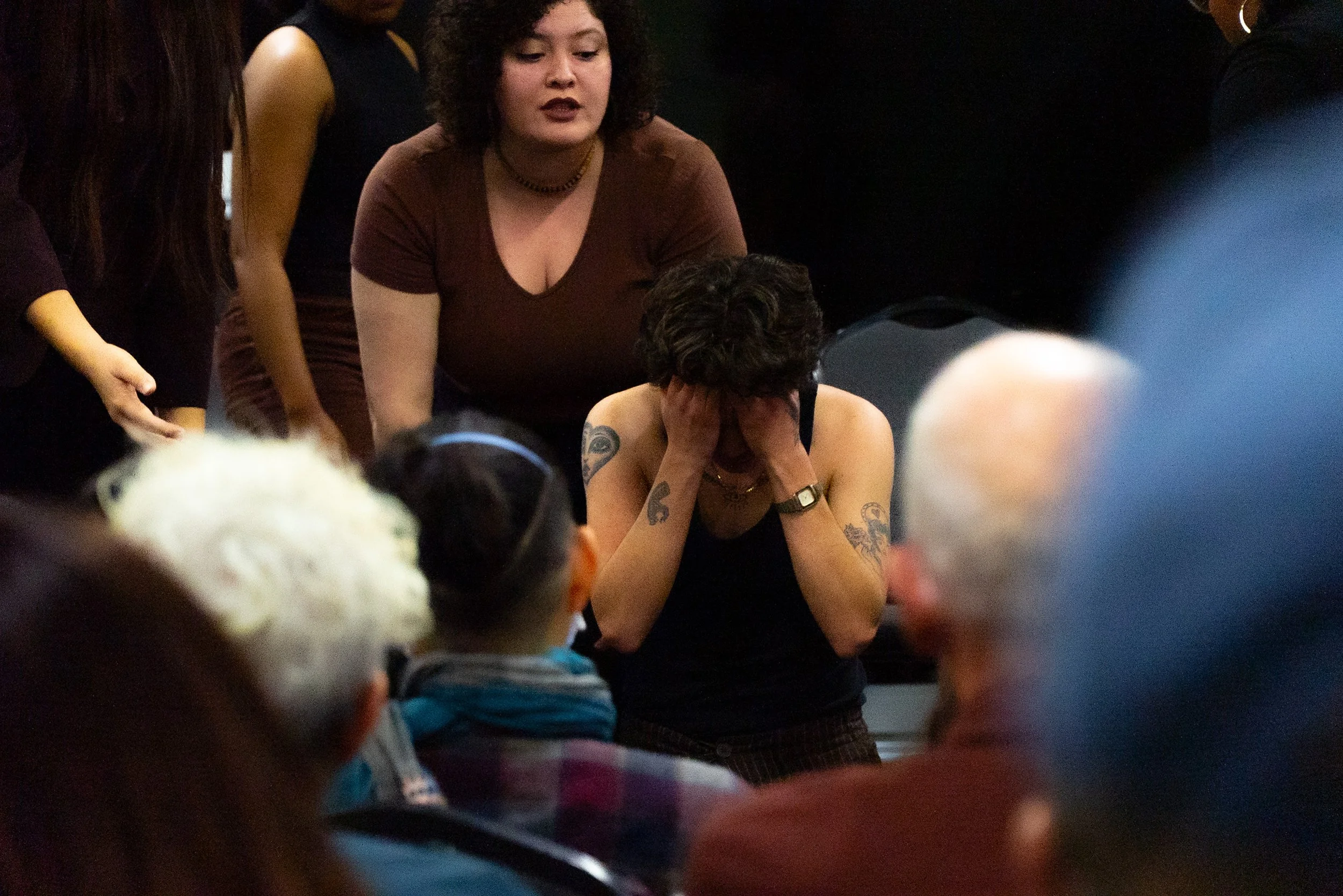 A performer on stage with his head in his hands