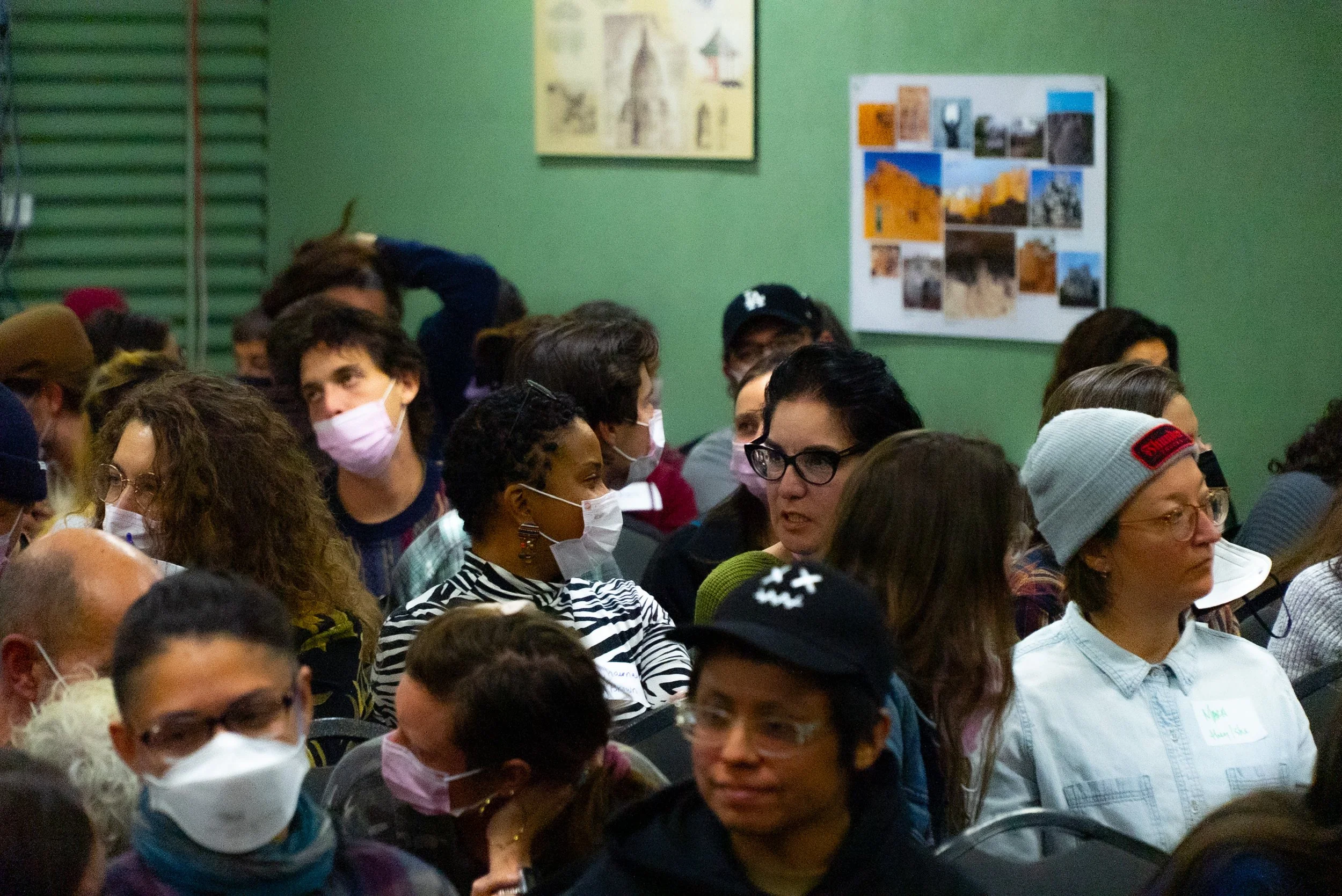 2 women are part of a larger audience while engaging in conversation