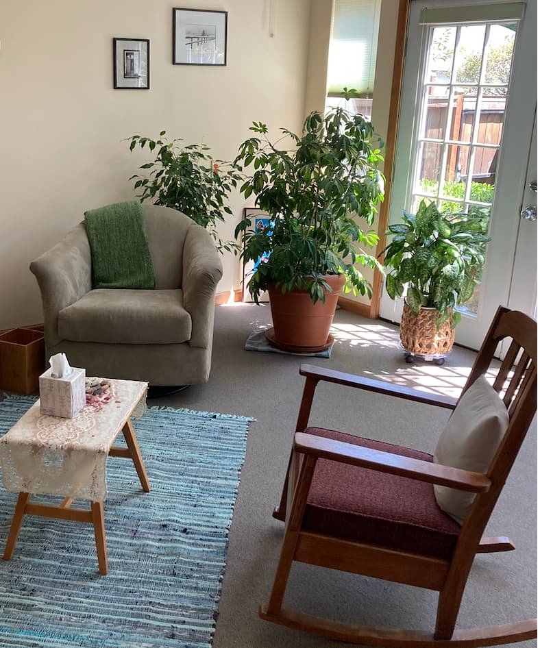 Two chairs facing each other in a therapy office with plants and natural light, Eugene Oregon therapist Tori Corbett