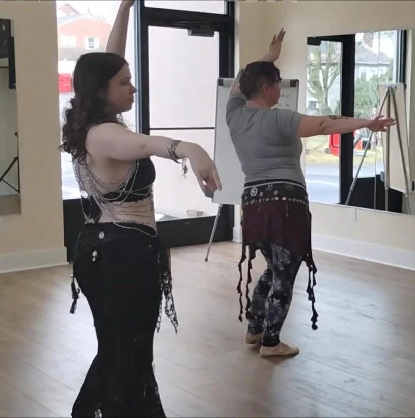 Two people dancing, one in partial costume the other if full costume