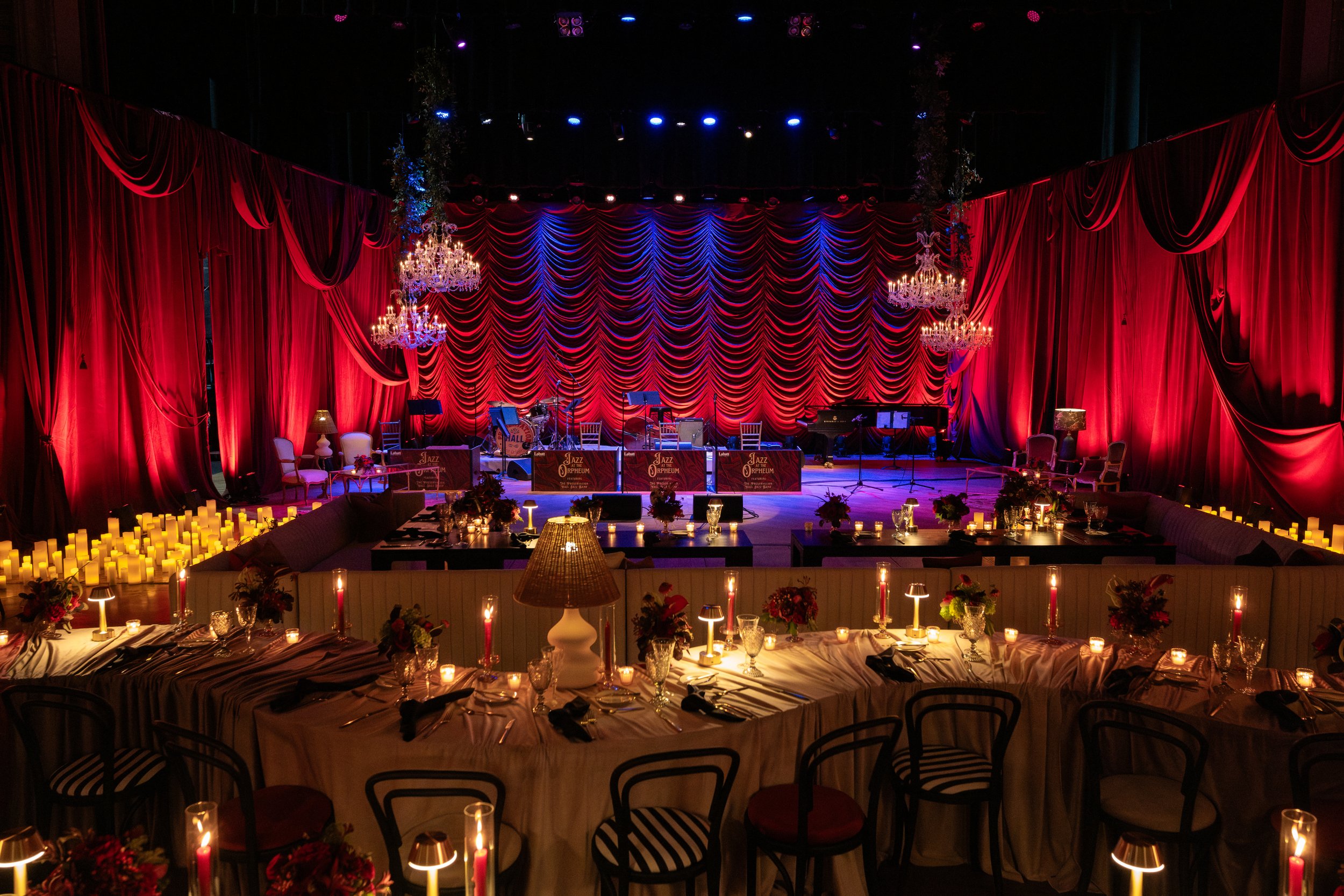 A corporate event design with round and rectangular tables, and lounge seating sofas at the Orpheum in New Orleans, Louisiana.