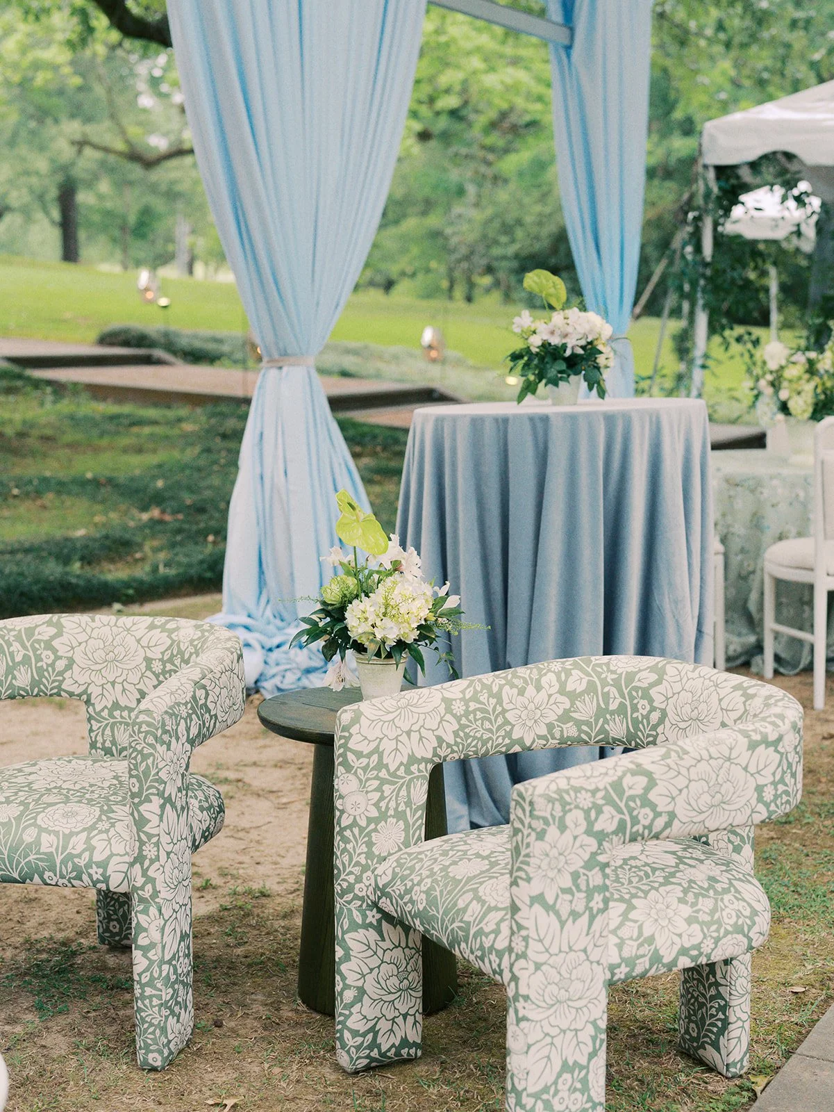 Luxury wedding reception lounge design with green floral lounge chairs at Field and Forest in Mississippi. 