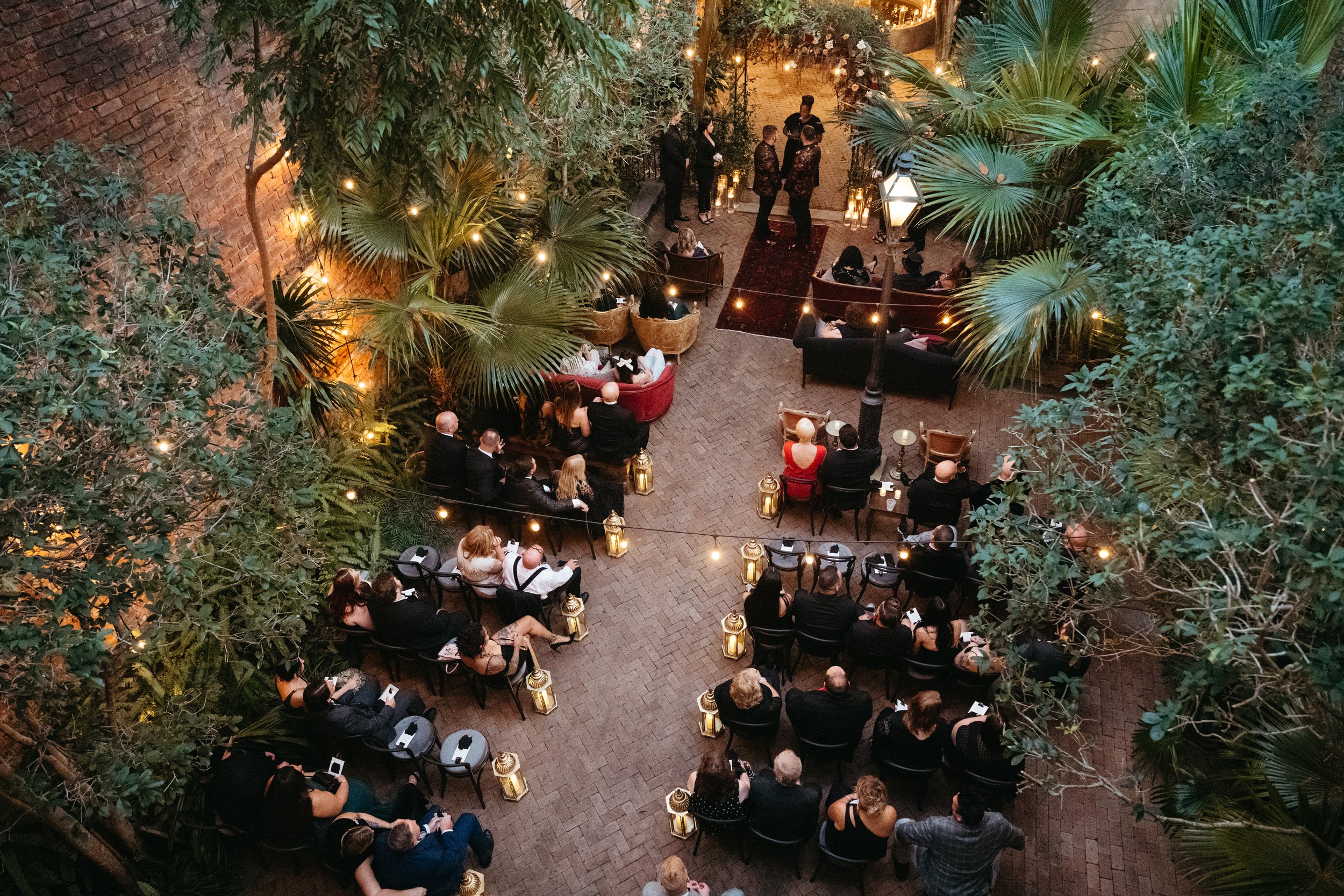 Guest enjoying an outdoor wedding ceremony at the New Orleans Pharmacy Museum.