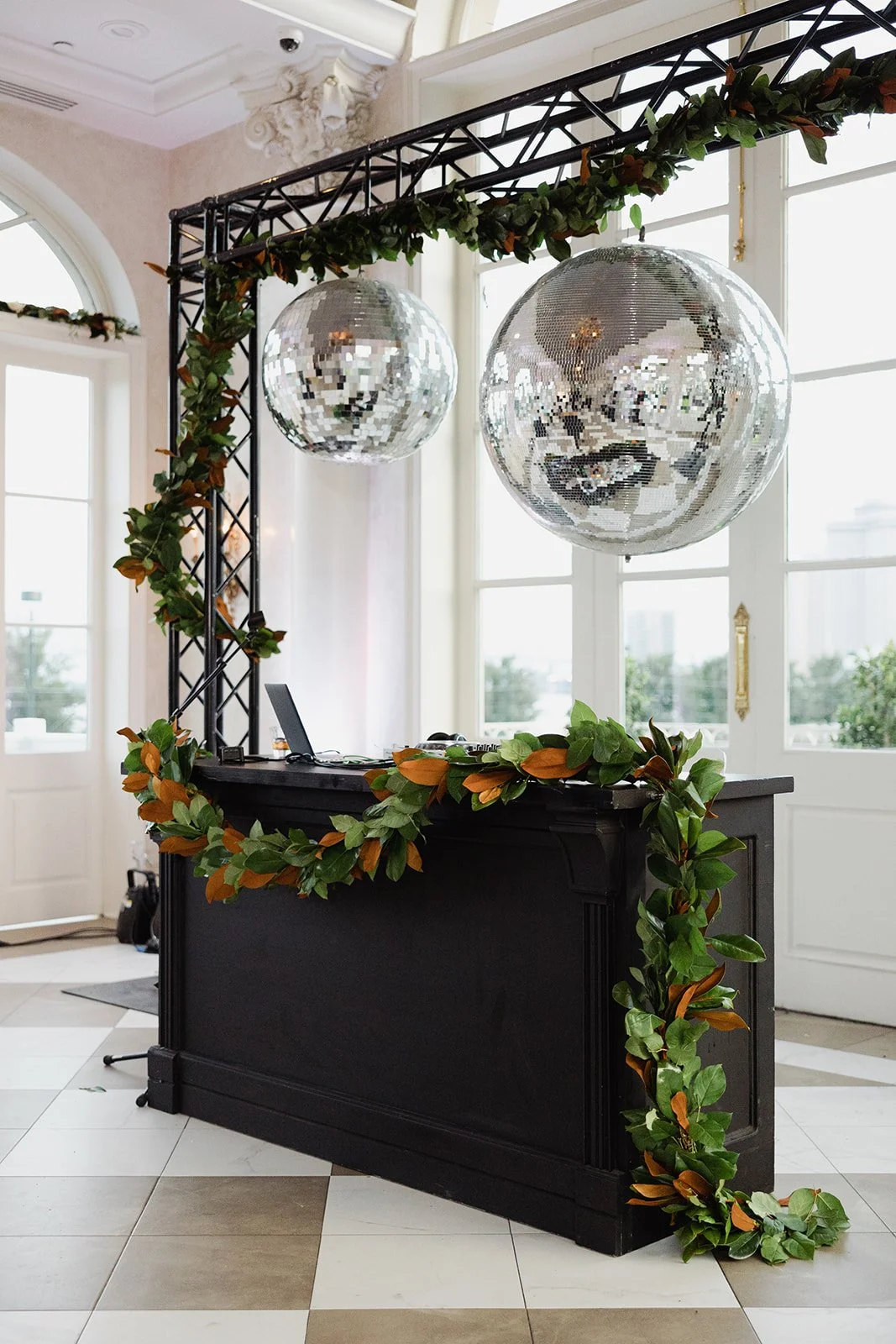 Wedding reception design with a black bar used as the DJ booth at Marche in New Orleans.