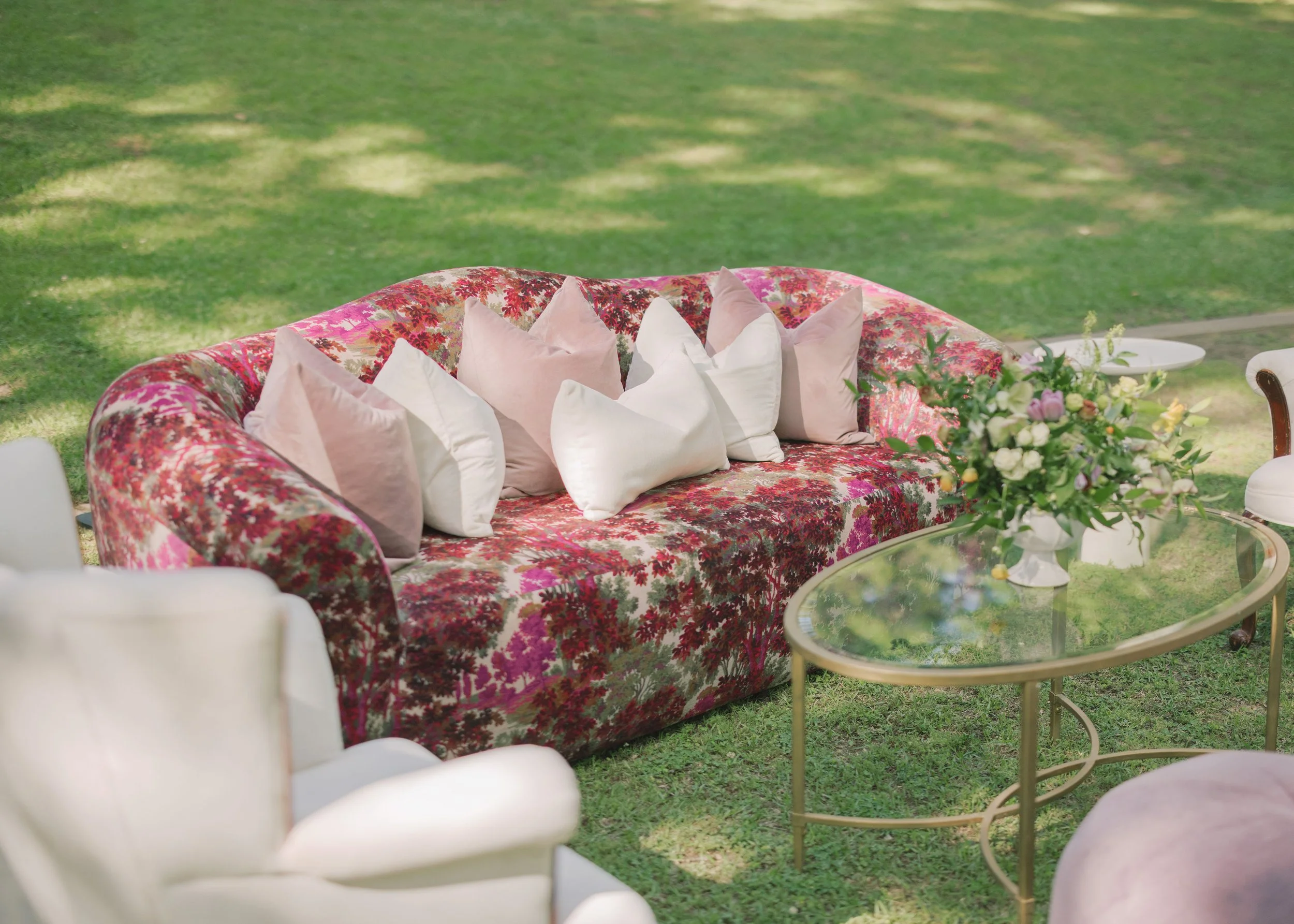 Luxury wedding reception with a pink floral modern sofa at Field and Forest in Mississippi. 