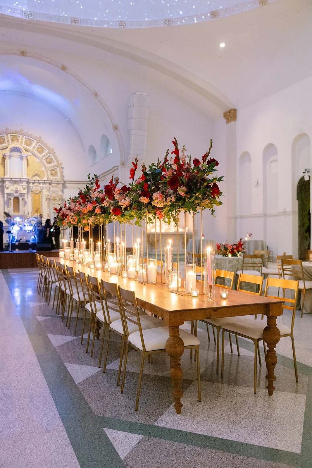 A wedding reception with a oak wood dining table and gold dining chairs at the Josephine in New Orleans.