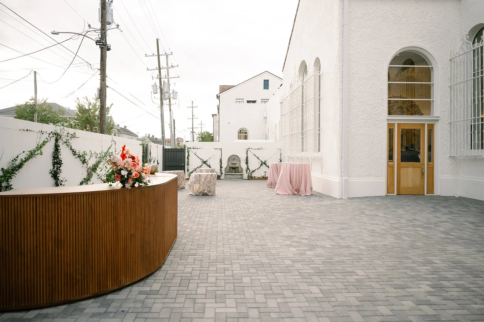 A outdoor wedding reception with a large walnut bar at the Josephine in New Orleans.