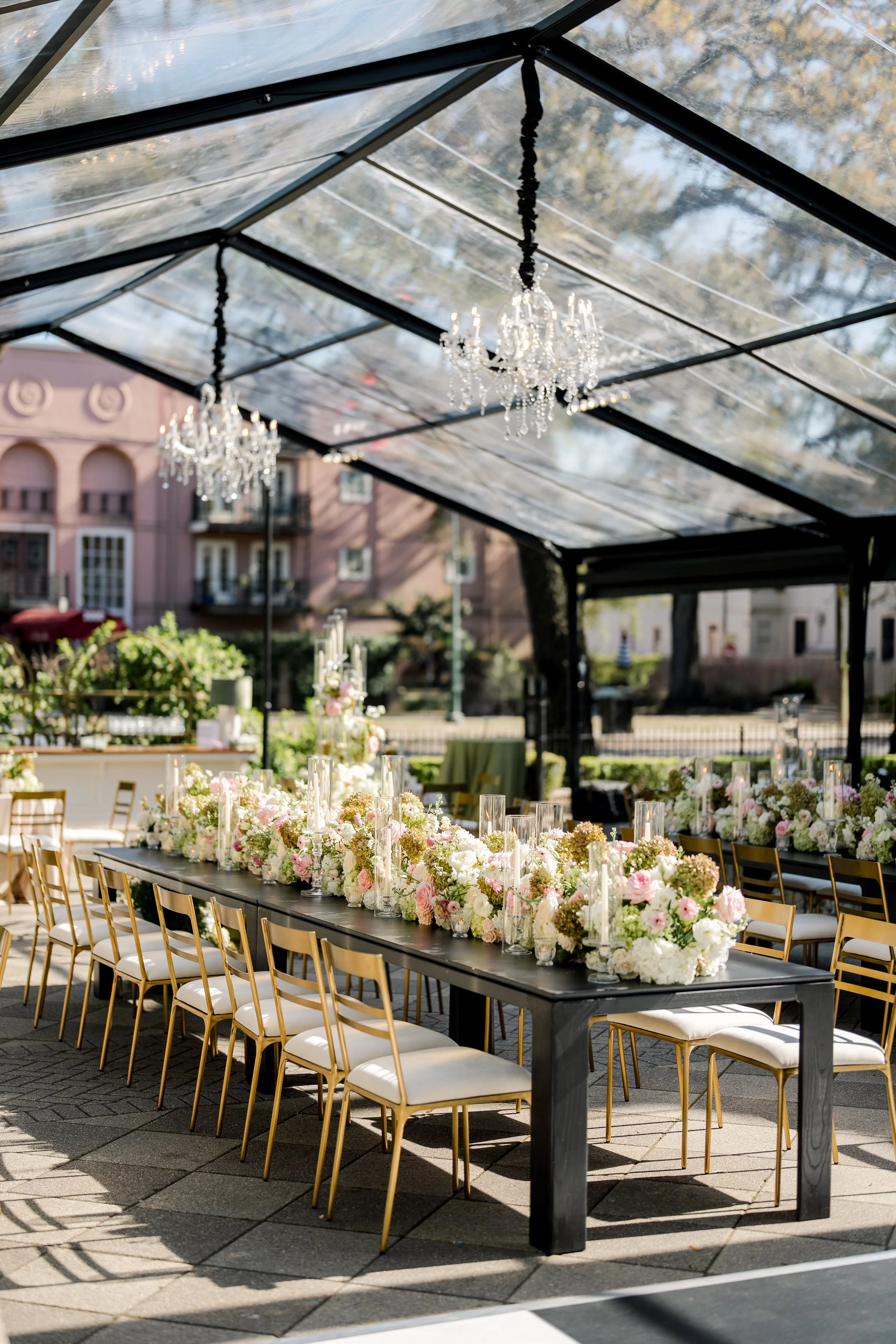Wedding reception seated dinner with gold dining chairs and modern black dining tables at Elms Mansion in New Orleans. 