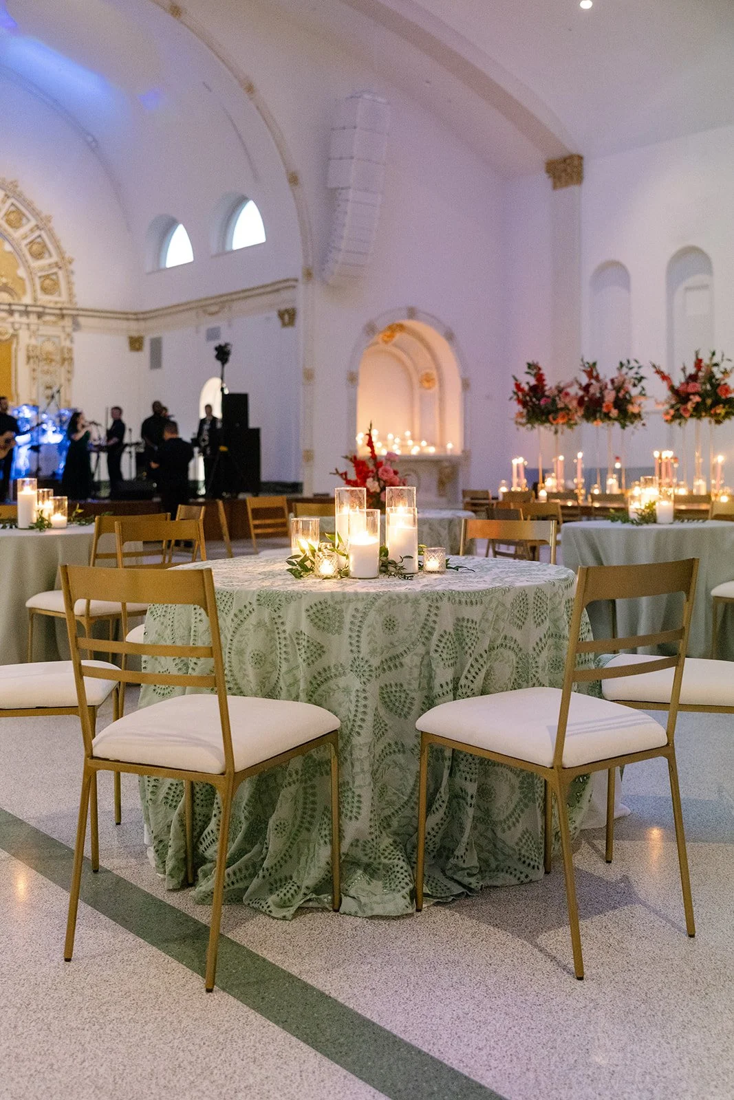 A wedding reception with gold dining chairs at the Josephine in New Orleans.