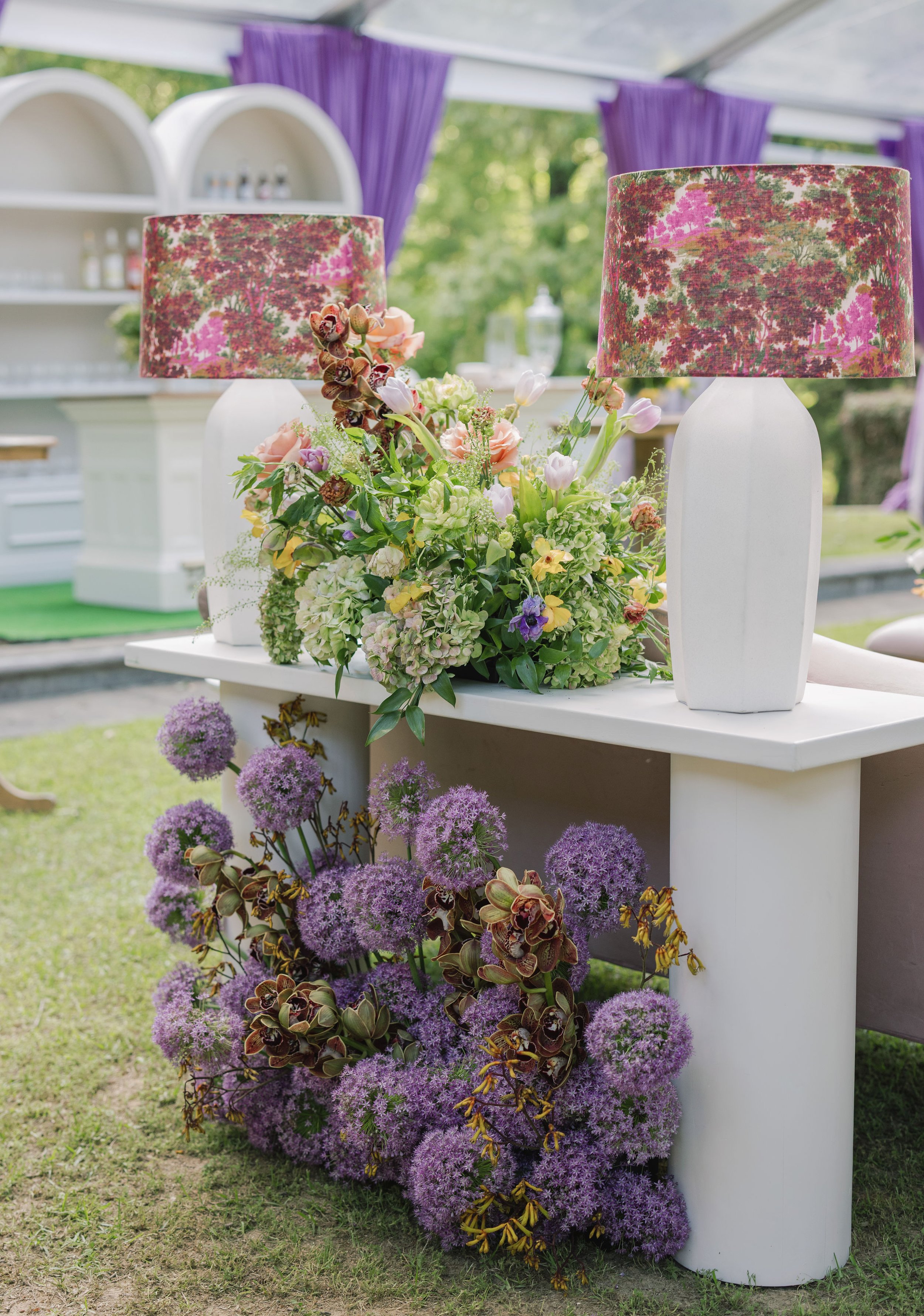 Luxury wedding reception design with white console tables and pink floral lamps at Field and Forest in Mississippi. 