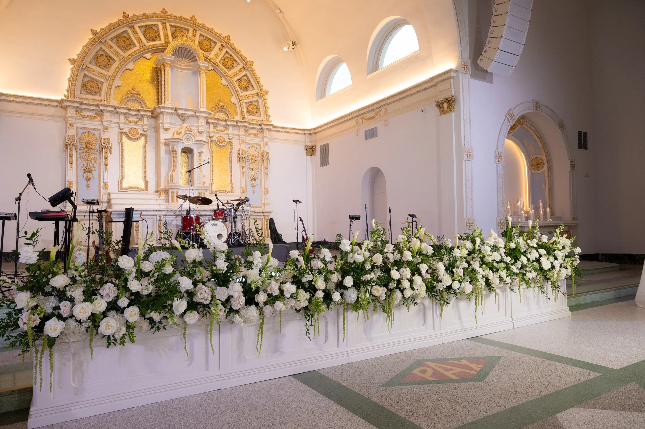 A wedding reception with white stage fronts at the Josephine in New Orleans.