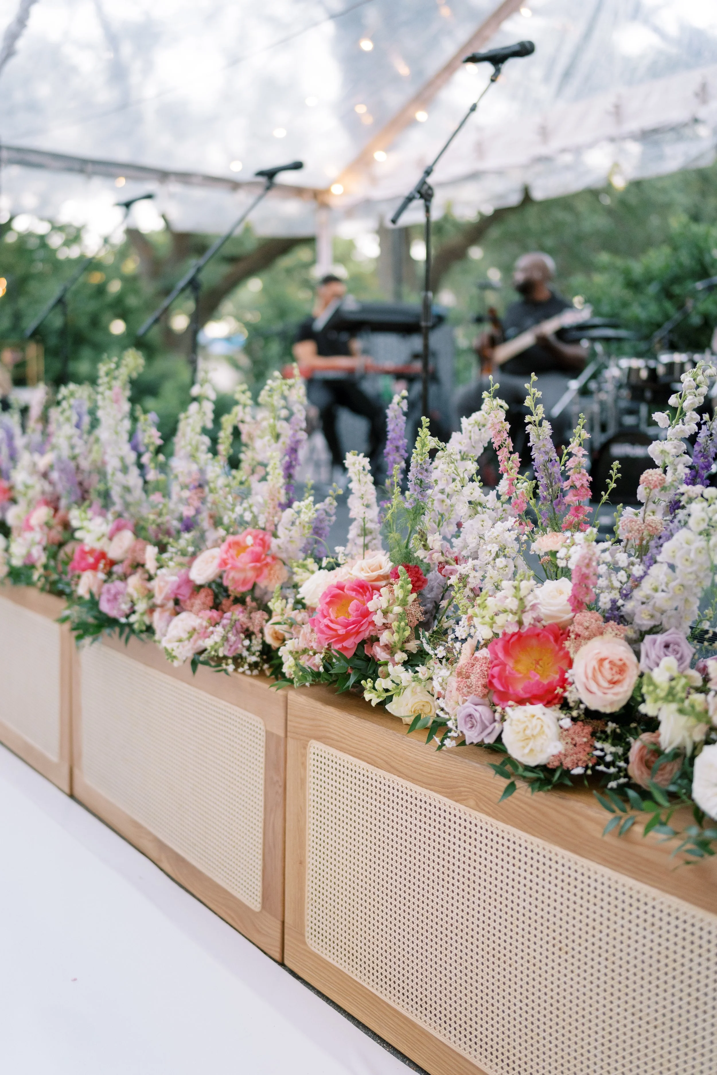A outdoor wedding reception design with natural cane stage fronts at the Elms Mansion in New Orleans. 