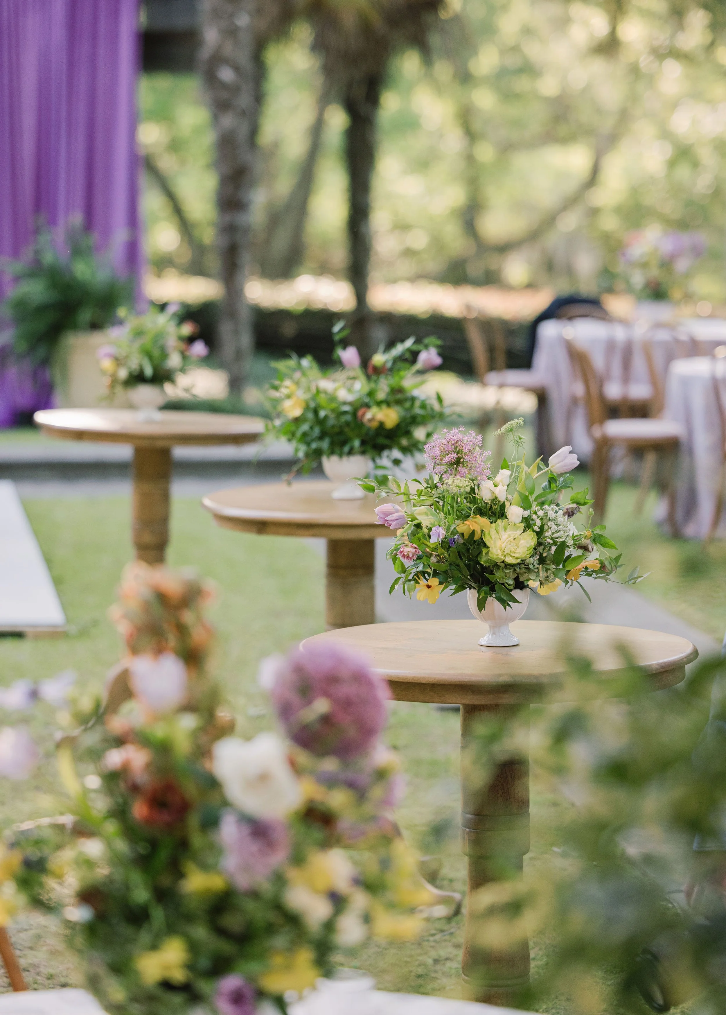 Luxury wedding reception design with natural wood highboys at Field and Forest in Mississippi. 