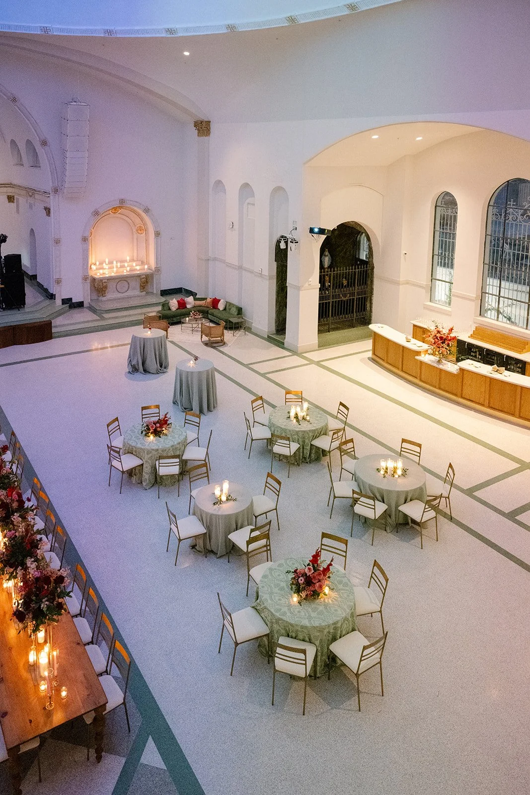 A wedding reception with gold dining chairs and tables at the Josephine in New Orleans.