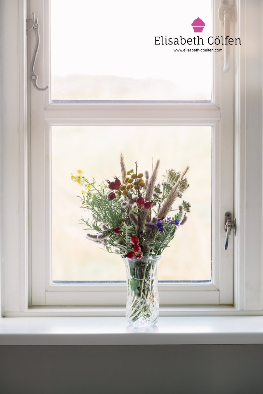 Wooden window with a bouquet of wild flowers found in the dunes in a window