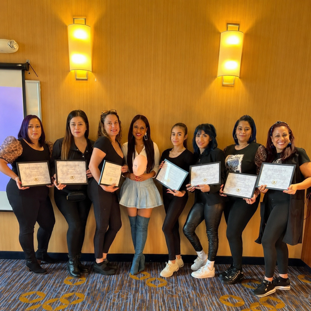 Lash Studio Academy graduates holding their certificates after group lash training