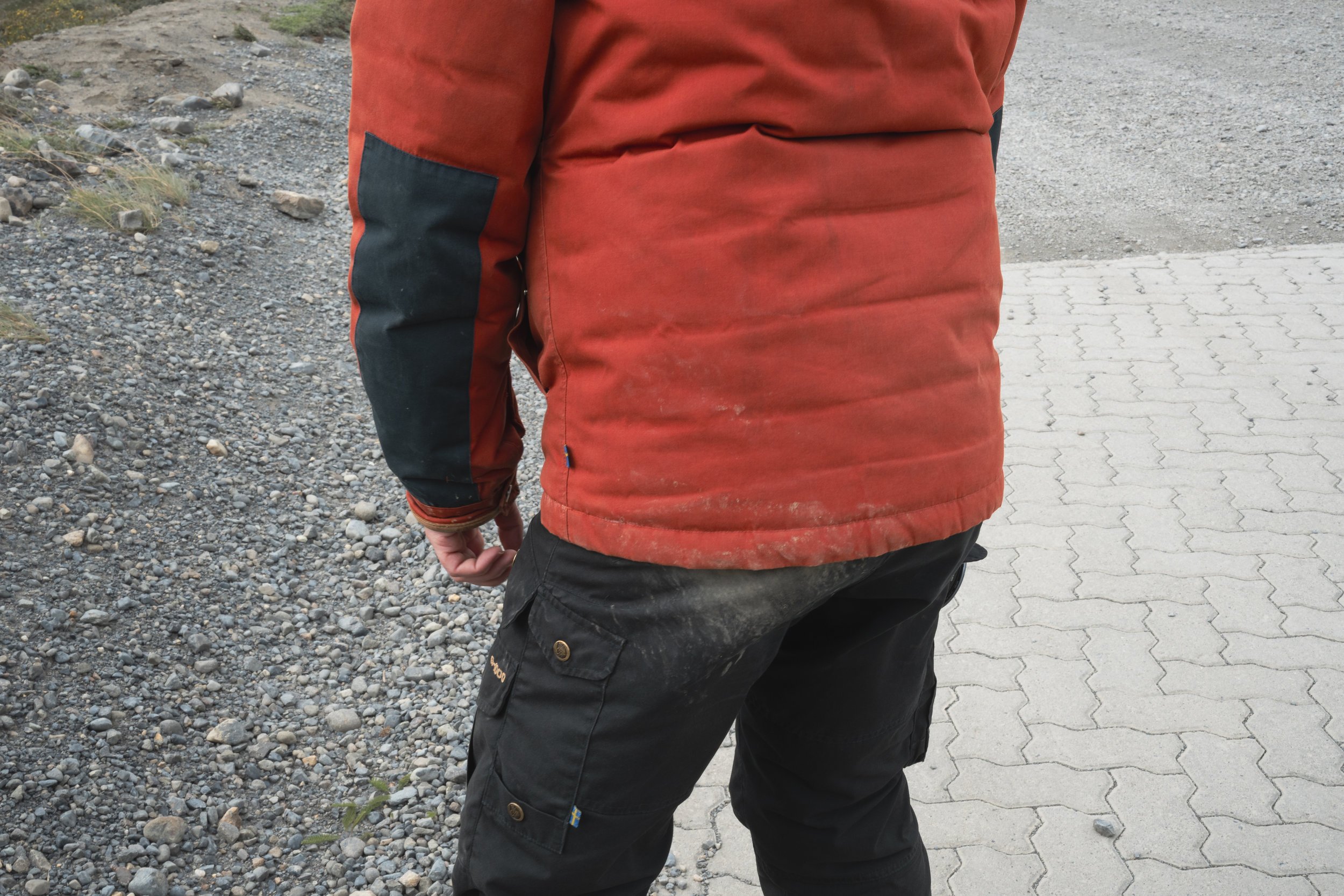 The back of a man who has just fallen over in the wind and got his backside dusty