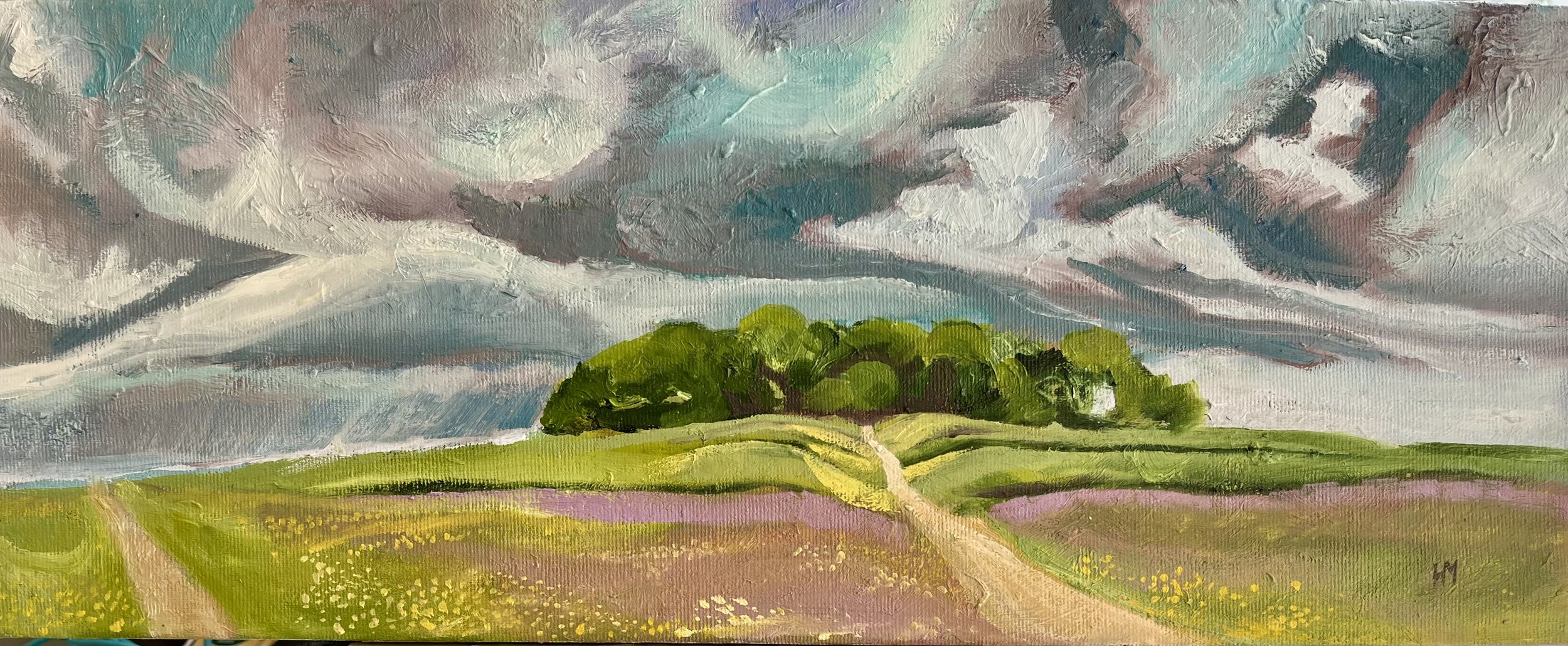 The image shows an original art oil painting of a clump of trees at the top of a  hill with a path leading up.  The clouds are sweeping above the trees, there are pink grasses and buttercups in the  meadow in front.