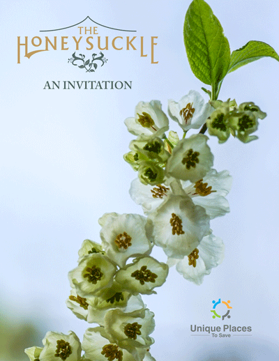 Invitation card for The Honeysuckle, featuring a vertical sprig of white honey-suckle flowers with green leaves, and the logo of Unique Places to Save.