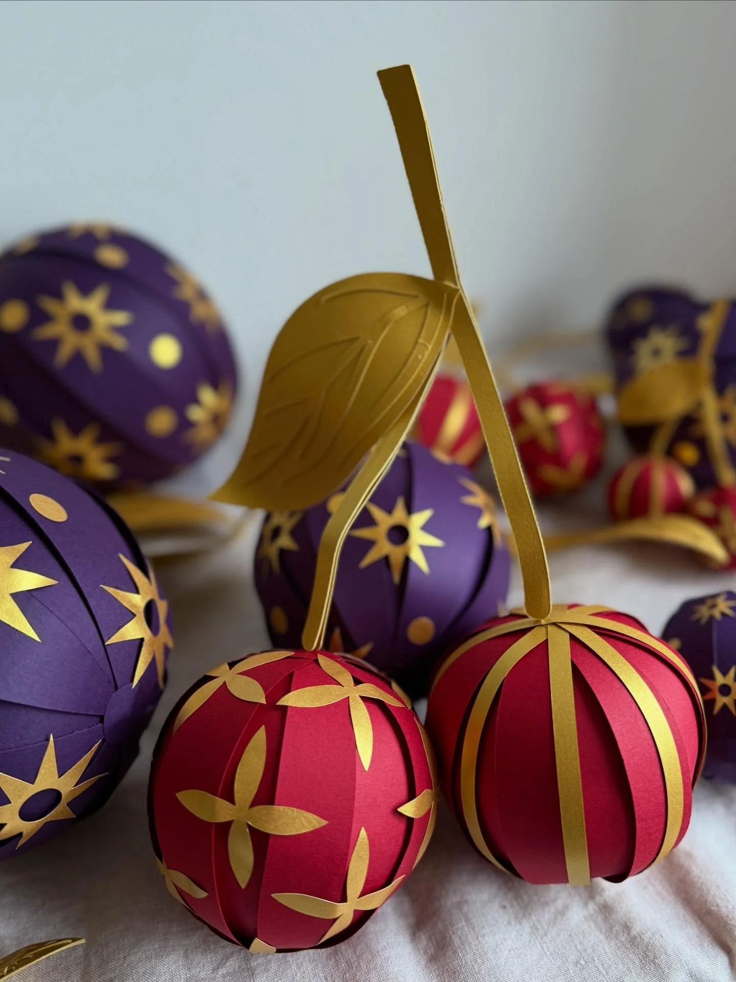 | CHERRIES 

6 days to go&hellip; has everyone got their pudding?

These decadent cherries were among a collection of sized fruits made for a very special Christmas window this year 🍒 any guesses? 🦚