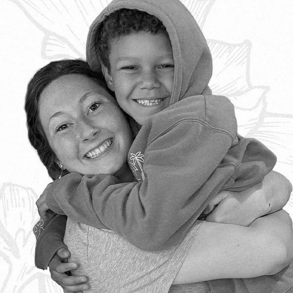 Happy photo of a young woman holding a smiling child.