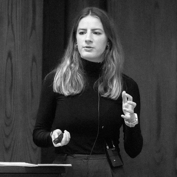 Portrait of a young woman giving a presentation in a conference room