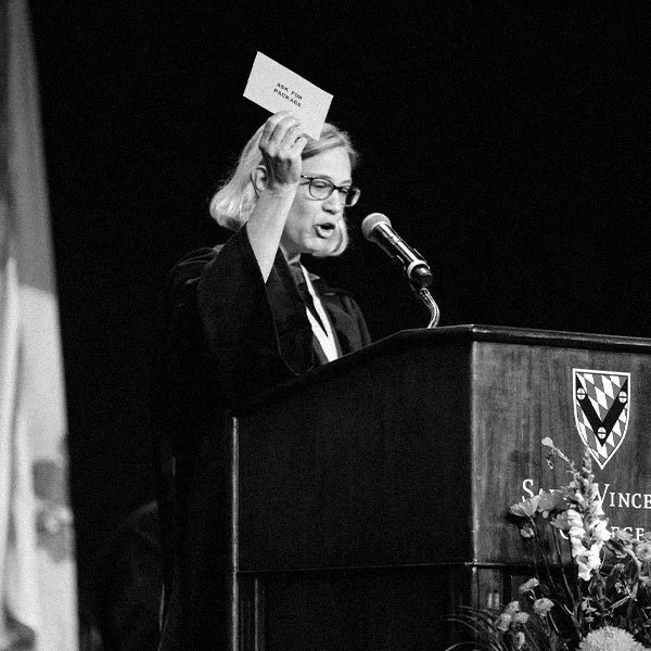 A cheerful emergency medical technician in uniform gently holds a baby girl, symbolizing compassion and community care.