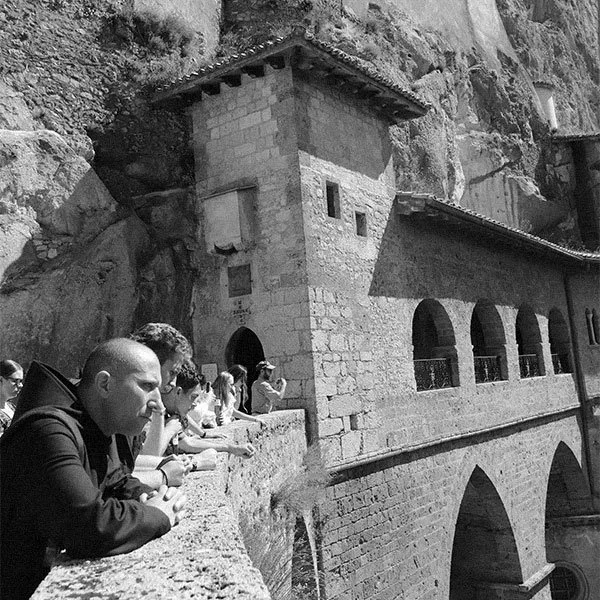 Photo of a monk and a group of college students sight seeing in Rome.