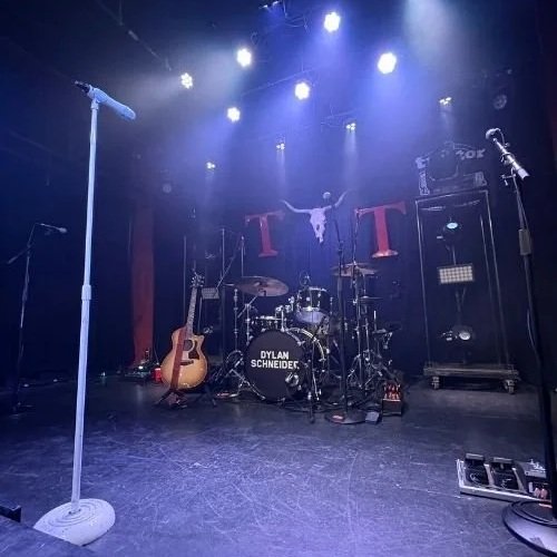 empty stage with mic stand and drums