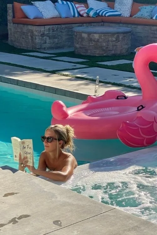 woman reading at the pool