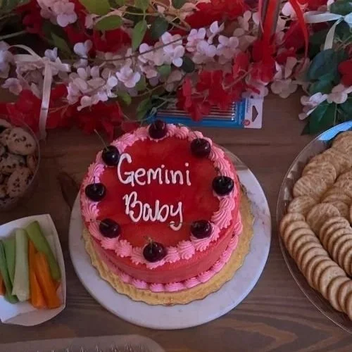 baby gemini pink cake on food table