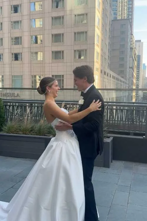 Bride and Groom Embrace on City Chicago Rooftop