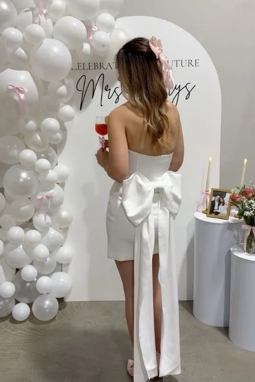 Bride with drink and photo bar with bows