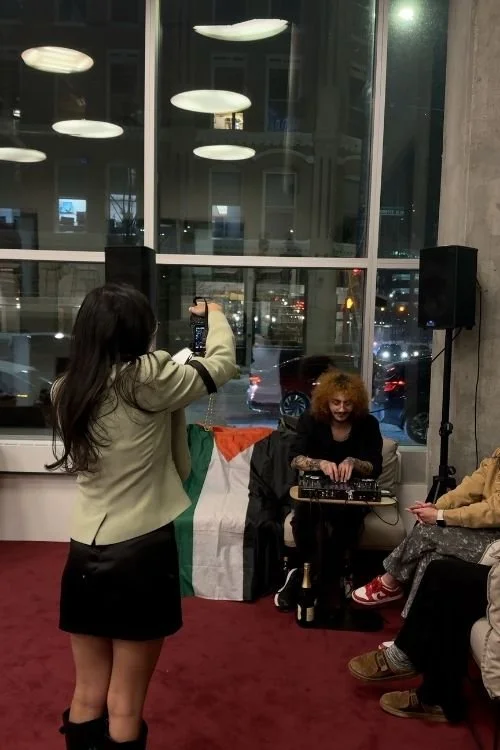 Woman holding camera taking photo at ecebt