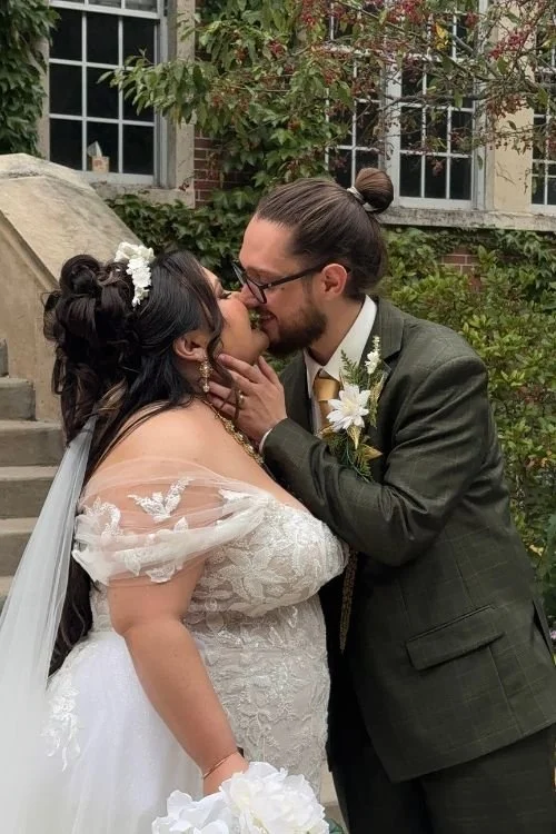 bride and groom kissing in wedding portraits