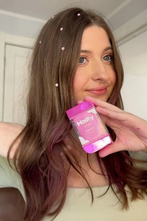 Woman holding mess free pink hair dye hally hair