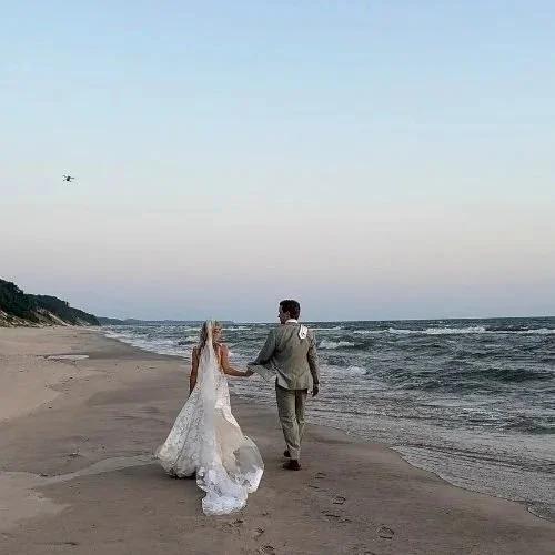 Bride and Groom walking on the beach