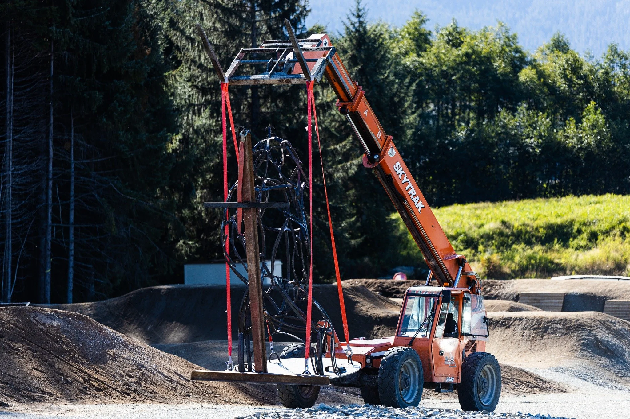Telehandler moving a grizzly bear sculpture in ktitmat BC
