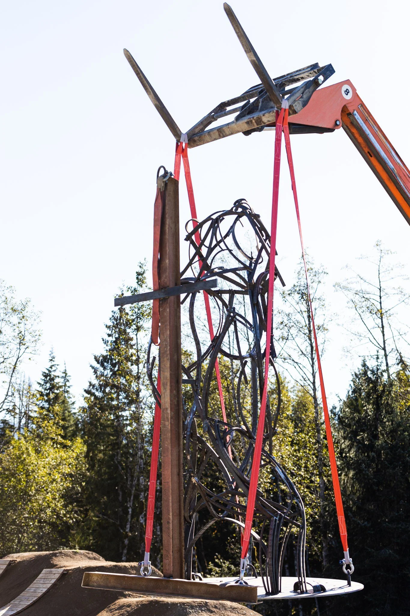 Lowering a sculpture onto a concrete pad