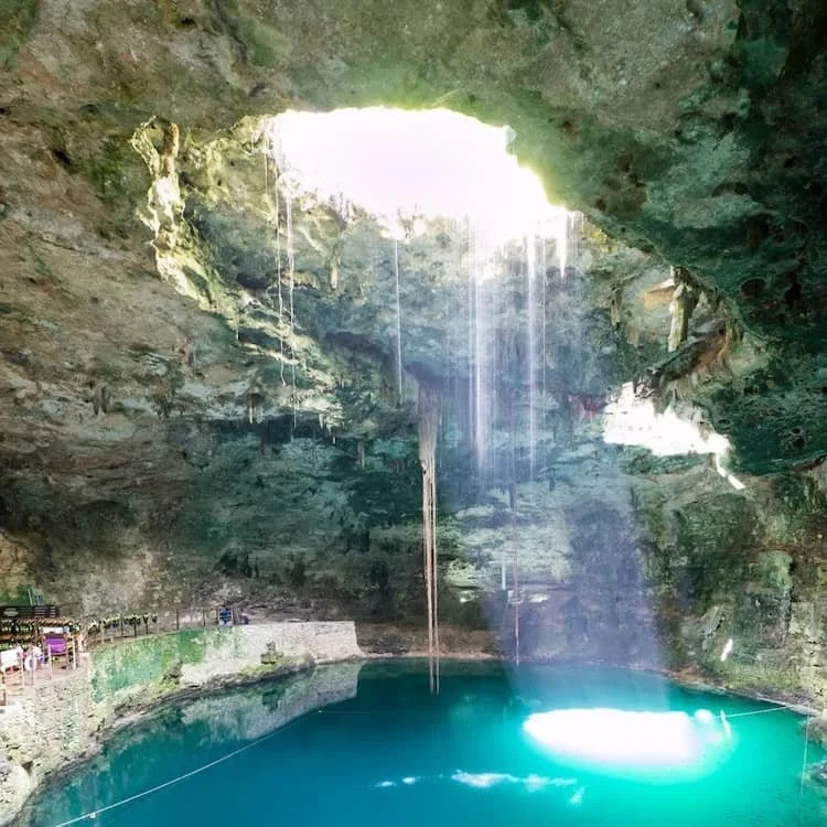 cenote with sun shining in on the water
