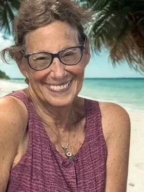 Sally Brucker standing by a palm tree in Mexico