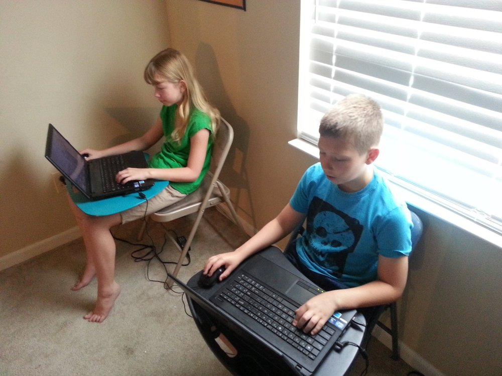 Beka Westberg (left) explores programming with her brother.