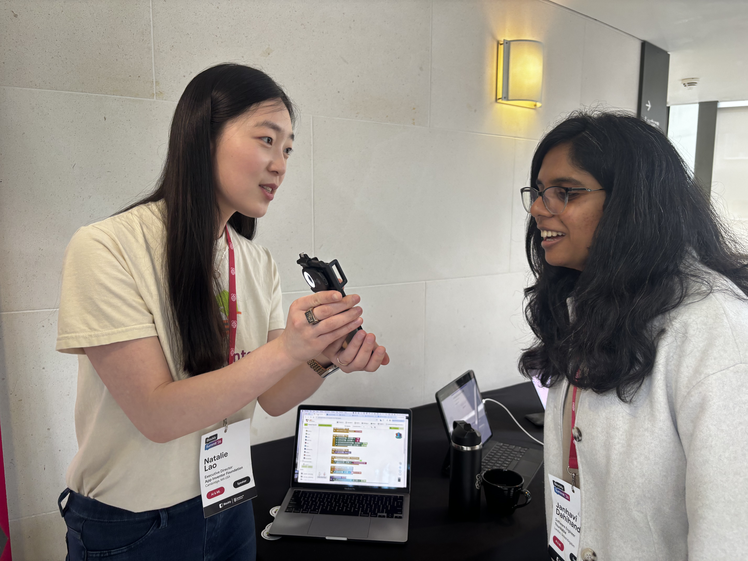 Natalie Lao next to tables, holding the AI2 in a Suitcase project for Janhavi Dahihand