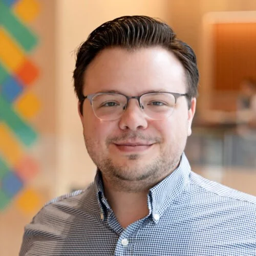 Vince Monardo with glasses and a collared shirt