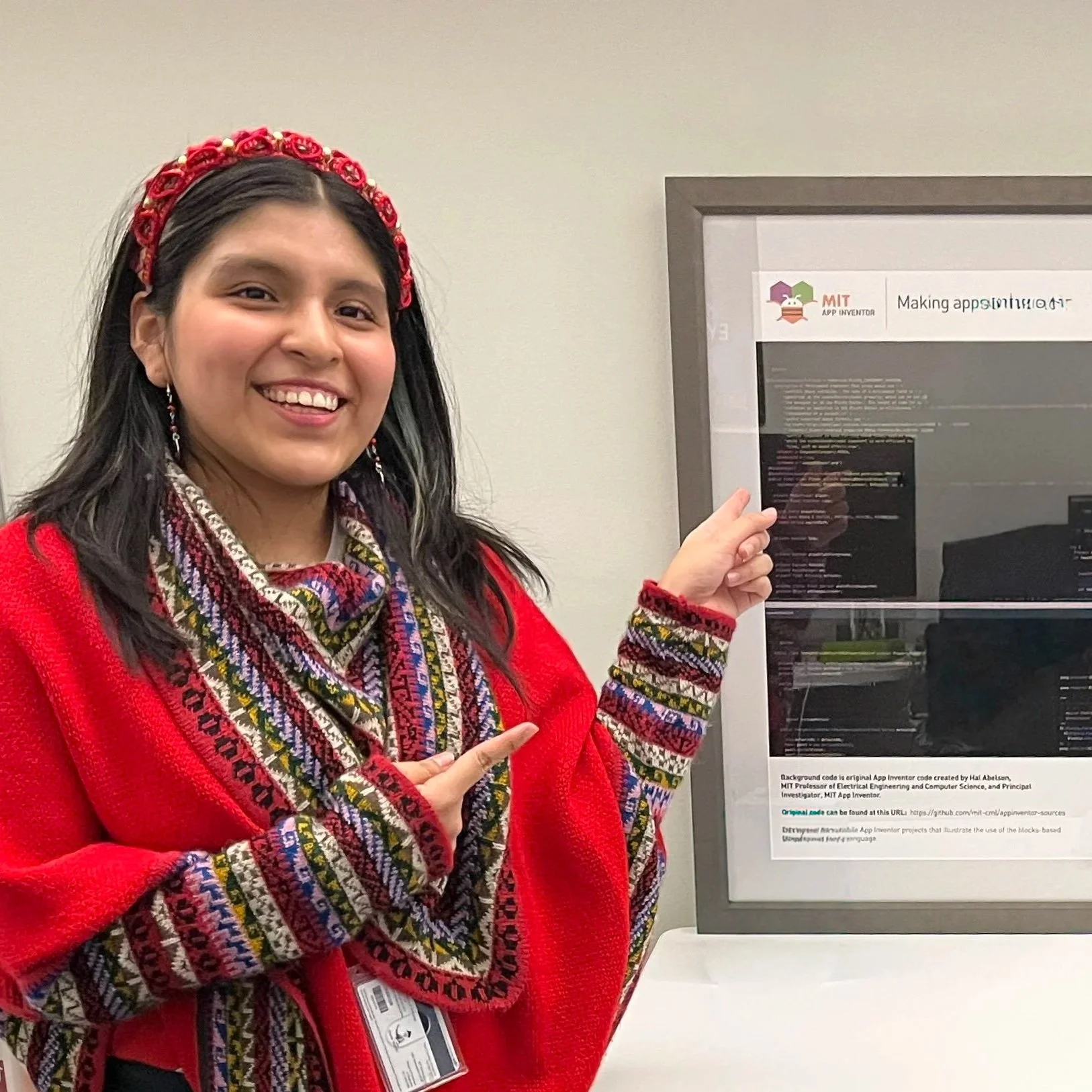 Isabella Sanchez Taipe pointing to App Inventor code